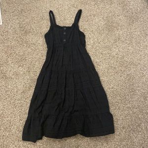 black dress with circle detailing and buttons